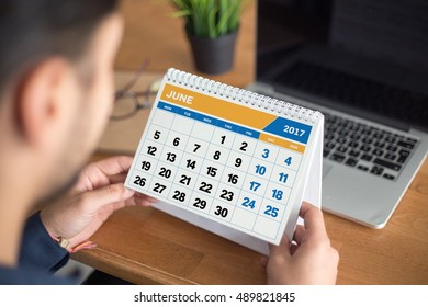 Businessman checking appointments in the calendar 2017 June at the office - Powered by Shutterstock