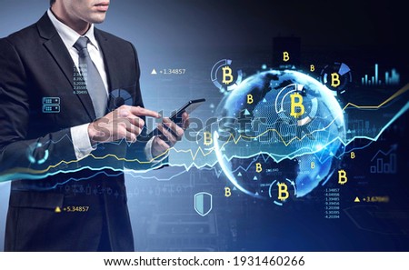 Businessman checking cryptocurrency, bitcoin stock market rate in smartphone. Hologram globe and charts. Business and financial success concept. double exposure.