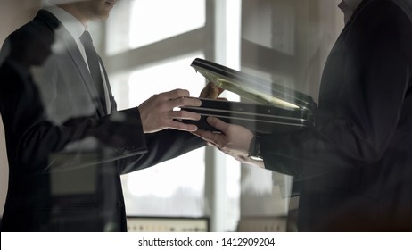 Businessman checking dollars in briefcase, kickback in illegal cooperation