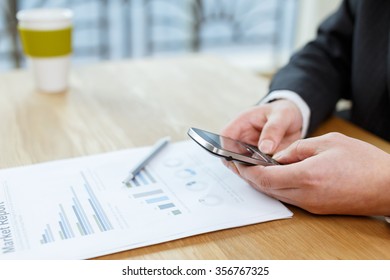 businessman checking financial report on table by using laptop,tablet and mobile phone