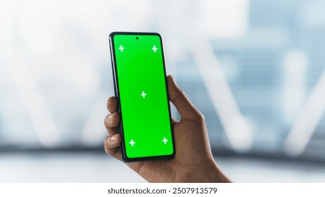 Businessman Checking a Social Network Post on Smartphone with Mock Up Green Screen Chromakey Display. Scrolling, Swiping, Tapping on the Mobile Phone. Concept for Online Services Presentation - Powered by Shutterstock