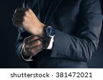 Businessman checking time from watch