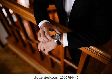 Businessman checking time from watch. Man looking on luxury watch. Gathering of groom on wedding day. - Powered by Shutterstock