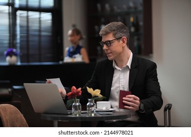 businessman checking a travelling passport. passengers in lounge  International airports. exclusive room - Shutterstock ID 2144978021