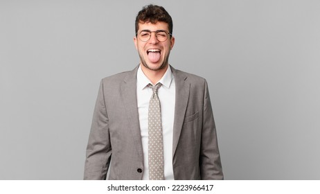 Businessman With Cheerful, Carefree, Rebellious Attitude, Joking And Sticking Tongue Out, Having Fun