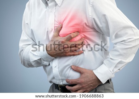 Businessman with chest pain holding his chest concept for heart attack, stoke or asthmatic