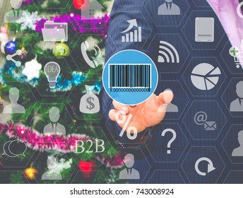 The businessman chooses  barcode on the touch screen, the backdrop of the Christmas tree and decorations. Special toning .