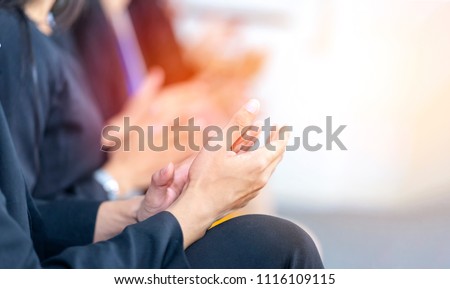Businessman clapping hands during seminar or teamwork meeting. Congratulation to  team member who receives award after business project success. Succeed from team collaboration, diversity idea, unity