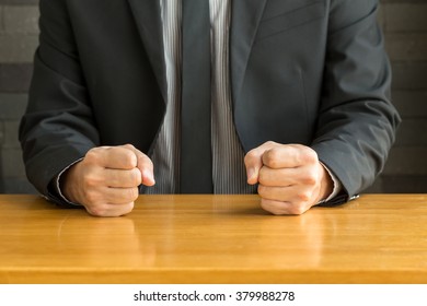 Businessman with clenched fist on the desk at office - Powered by Shutterstock