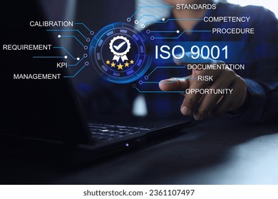 Businessman click to approve ISO 9001 standards quality assurance on laptop to management system in global business has been certified by the auditor certified body. Quality control and assurance