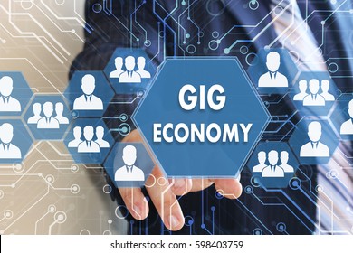 The businessman clicks the button GIG ECONOMY on the touch screen with a futuristic background . - Shutterstock ID 598403759