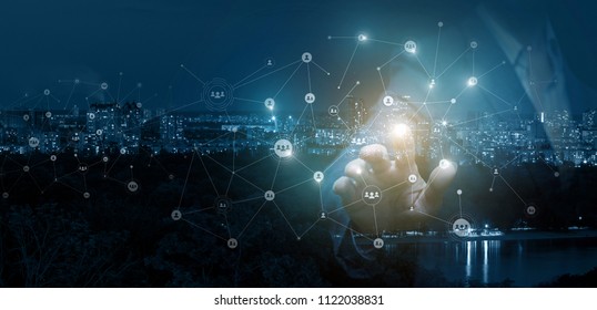 Businessman clicks on the avatar in the network on the background of night city. - Shutterstock ID 1122038831