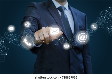 Businessman clicks on the letter. Concept contact us. - Shutterstock ID 718929985