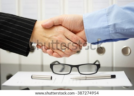 Businessman and client are handshaking over very good agreement