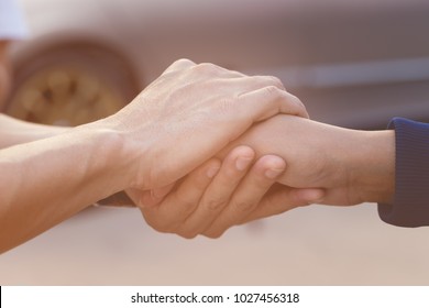 Businessman with client holding hands together for comfort and support work together, insurance team,respect and trust concept