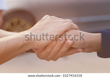 Businessman with client holding hands together for comfort and support work together, insurance team,respect and trust concept