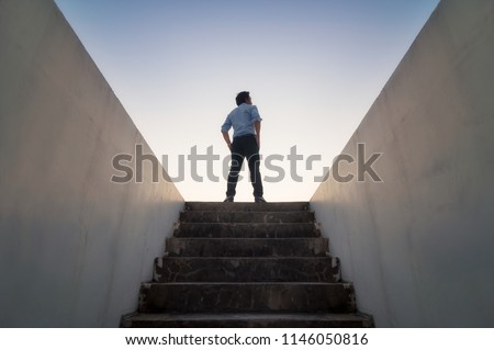 Businessman climbed on top of the stairs going to the city,  Ambitions concept and Success business.