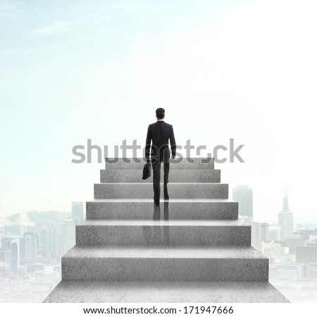 businessman climbing to stairs on city background