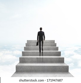 Businessman Climbing To Stairs On Sky Background