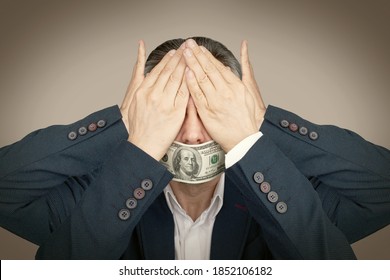 Businessman closed his eyes and ears. Mouth is closed with dollar. Corruption and bribery concept. Toned image