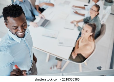 Businessman, Coaching And Team In Boardroom Meeting On Whiteboard For Training Staff At The Office. Black Man Leader, Mentor Or Executive Teaching Employee Workers In Sales Marketing At The Workplace