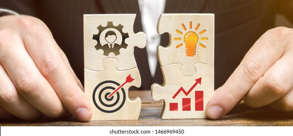 Businessman collects puzzles with the image of the attributes of doing business. Strategy planning concept. Organization of the process. Creating a business model. Management. Research, marketing. - Shutterstock ID 1466969450