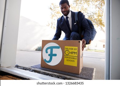 Businessman Coming Home To Fresh Food Home Delivery In Cardboard Box Outside Front Door