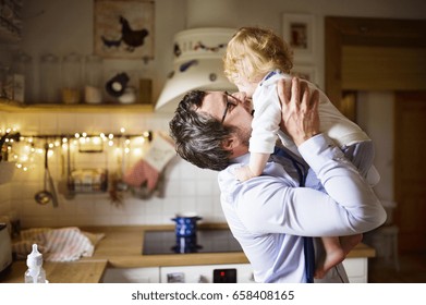 Businessman Coming Home From Work, Kissing His Little Son.