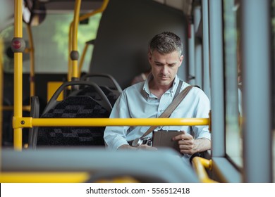 Businessman Commuting To Work By Bus And Working With A Digital Touch Screen Tablet