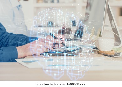 Businessman with computer background with brain theme hologram. Concept of brainstorm. Multi exposure.