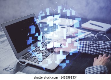 Businessman with computer background with technology theme hologram. Concept of hightech. Multi exposure.