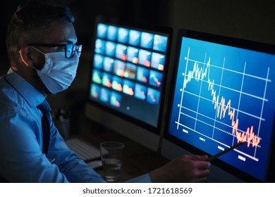Businessman with computer sitting at desk, working late in office. Financial crisis concept. - Shutterstock ID 1721618569