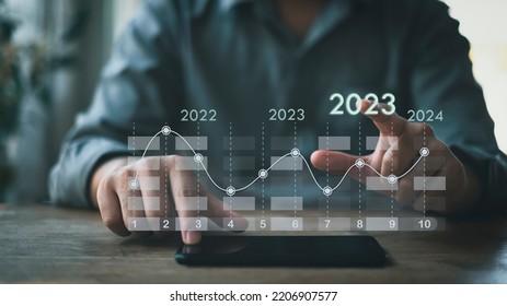 Businessman concept, analyzing workability and examining information for investment with new digital virtual screen graphics, 2023. - Shutterstock ID 2206907577