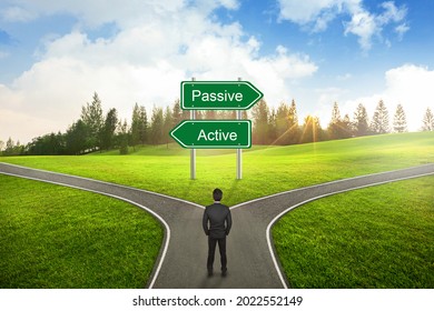 Businessman concept, Businessman standing between Active or Passive sign road to the correct way.