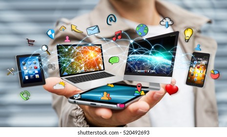 Businessman connected tech devices and icons applications with his mobile phone 3D rendering - Shutterstock ID 520492693