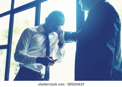 Businessman Consoling His Friend After Meeting For Business Mistake.