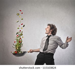 Businessman Cooking Vegetables With A Pan