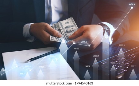 
Businessman Counting The Money Earned From Forex. Financial Stock Market Graph.Business Investment And Currency Exchange.