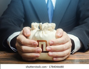 Businessman covers with hands israeli shekel money bags. Corrupt schemes. Profit collection and tax withholding. Hit jackpot. Capital. Budget absorption. Accumulation of funds, bank loan. Investments. - Shutterstock ID 1784046680