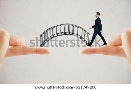 Businessman crossing abstract drawn bridge leading from finger to finger