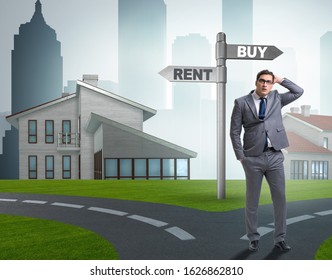 Businessman At Crossroads Betweem Buying And Renting