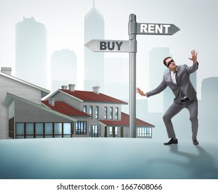 Businessman At Crossroads Betweem Buying And Renting