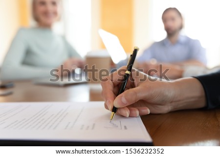 Businessman customer bank loan service buyer sign paper document at meeting, male client buy insurance get hired make business deal write signature on employment contract agreement, close up view