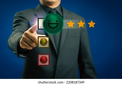 Businessman or customer give rating to service experience on virtual touch screen and finger pressing smiley face emoticon to review satisfaction feedback survey, Customer service evaluation concept - Shutterstock ID 2208187349