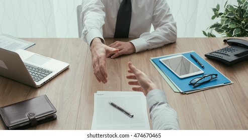 Businessman And Customer Having A Business Meeting In The Office Before Signing A Contract, Point Of View Shot