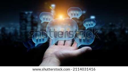 Businessman in dark using digital blue speech bubbles talk icons. Minimal conversation or social media messages floating over user hand. 3D rendering