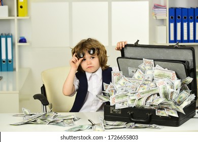 Businessman, Deal And Money. The Boy Makes An Emotional Face With Sunglasses. Lots Of Cash At Home. Financial Security. Financial Education For Children.