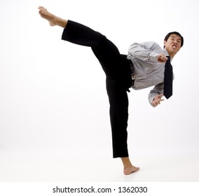 A Businessman Demonstrates A Roundhouse Kick