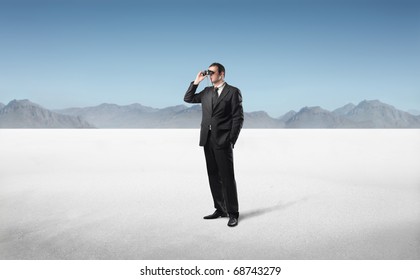 Businessman in a desert using binoculars - Powered by Shutterstock