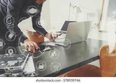 Businessman Or Designer Using Smart Phone With Laptop And Digital Tablet Computer And Document On Desk In Modern Office With Virtual Interface Graphic Icons Network Diagram